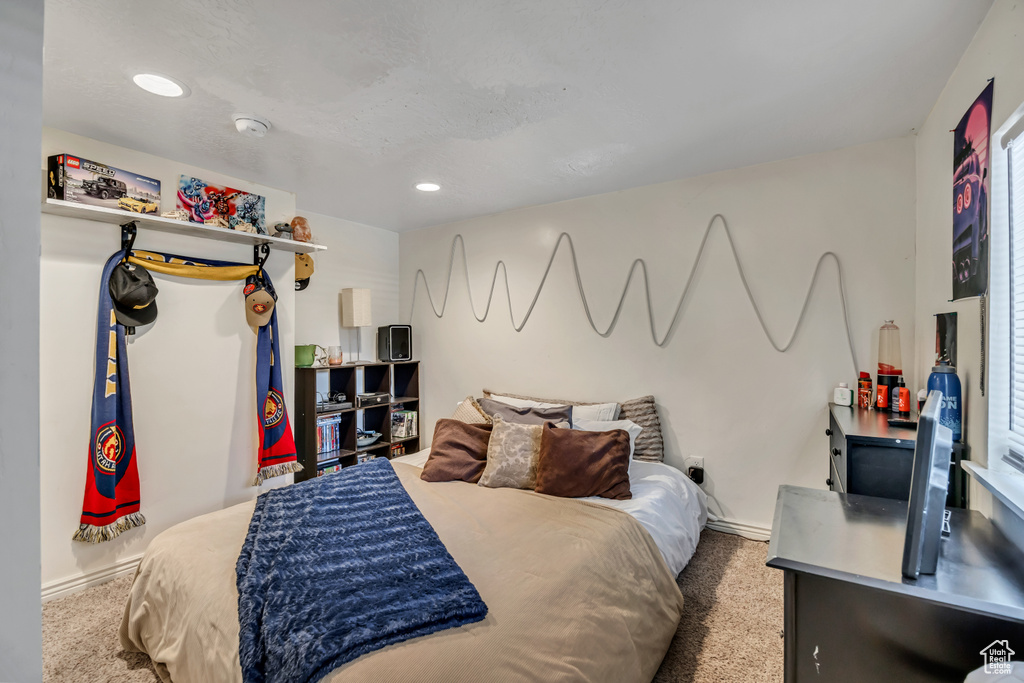 Carpeted bedroom with baseboards and recessed lighting