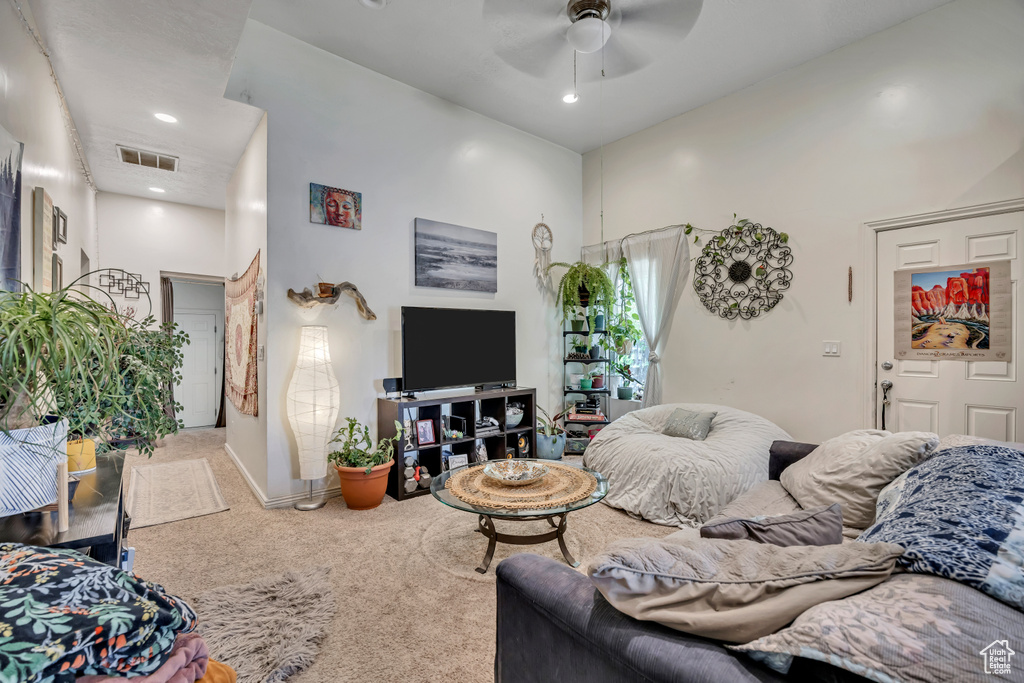 Living area featuring carpet floors, a ceiling fan, a towering ceiling, and recessed lighting