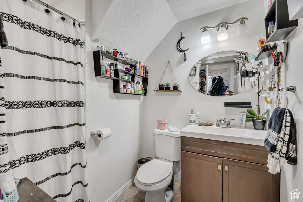 Bathroom featuring vanity, a shower with shower curtain, and a textured ceiling