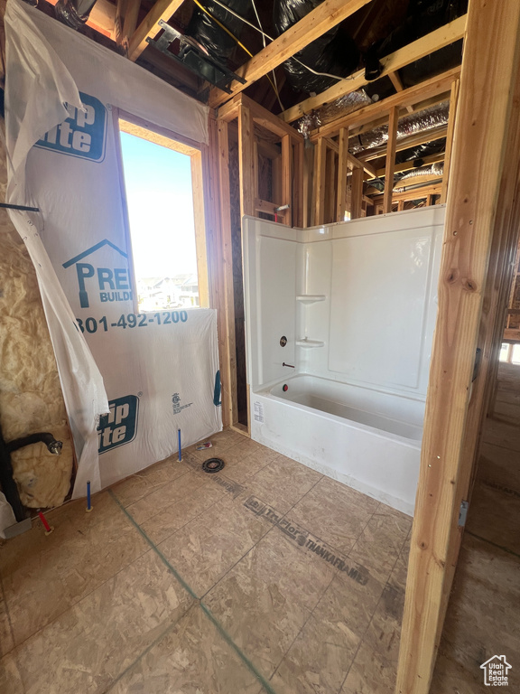 Full bath featuring washtub / shower combination