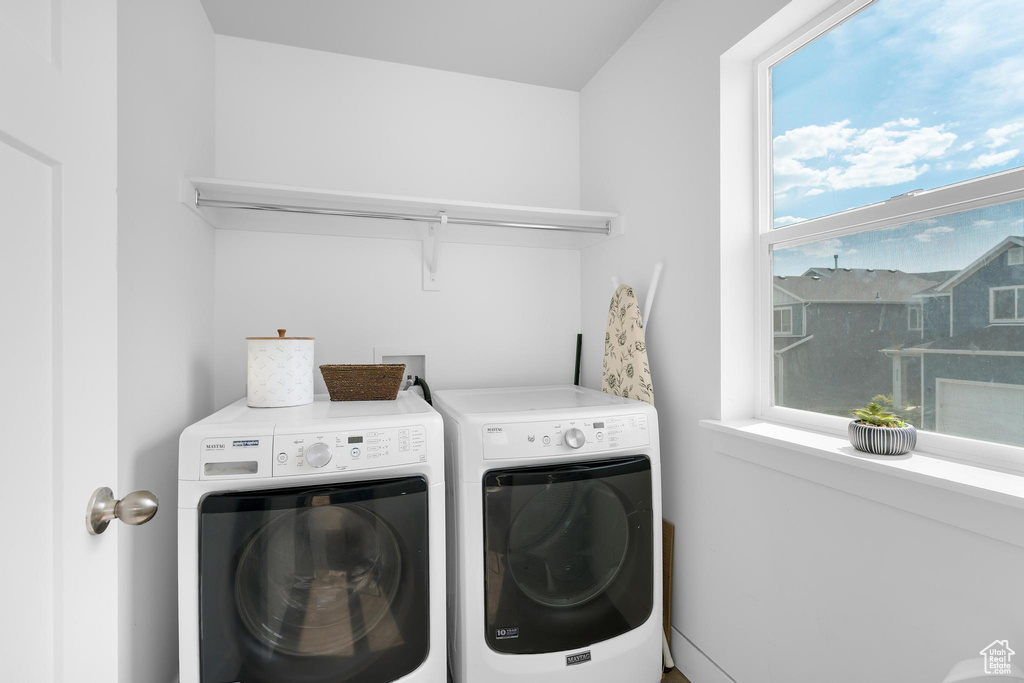 Washroom with washer and clothes dryer
