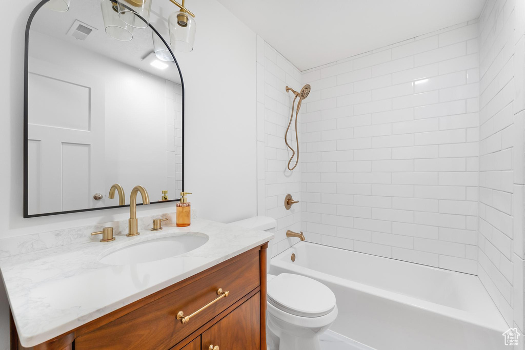 Bathroom featuring vanity and shower / washtub combination