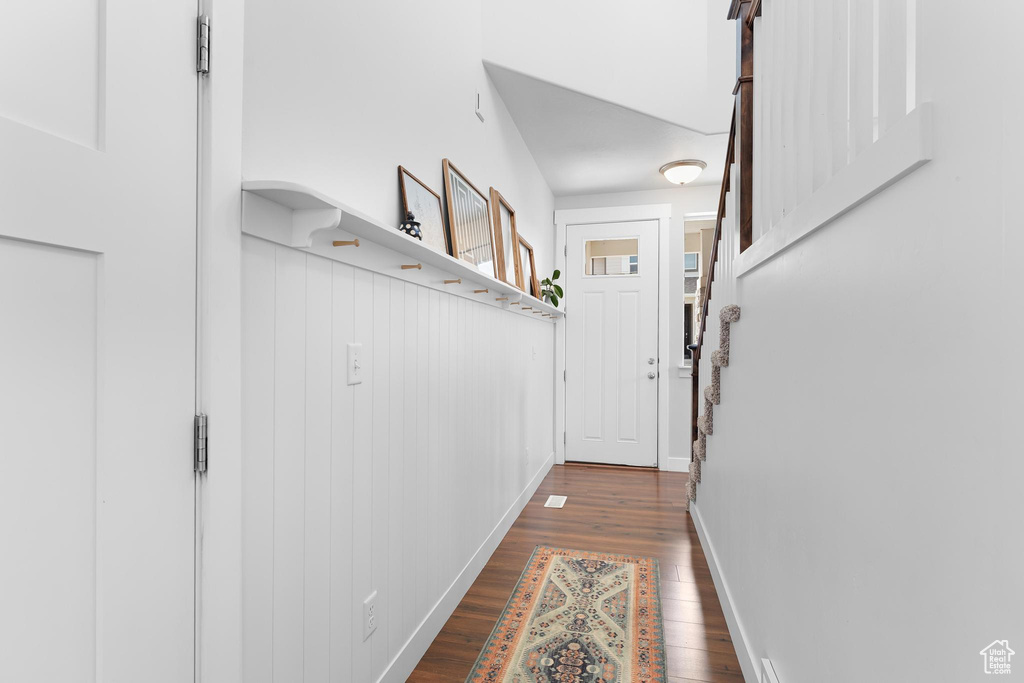 Doorway to outside featuring wood finished floors and baseboards