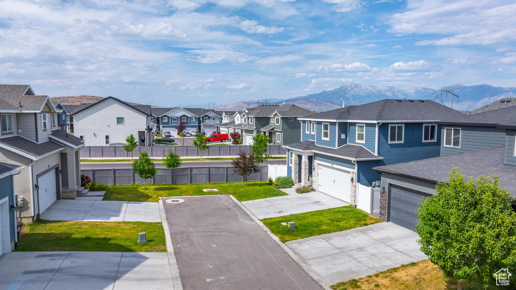 View of yard with a residential view, a mountain view, and driveway