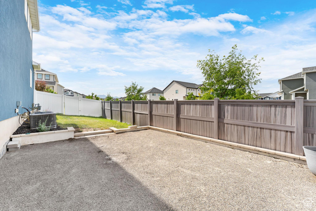 Fenced backyard featuring a patio area and a residential view