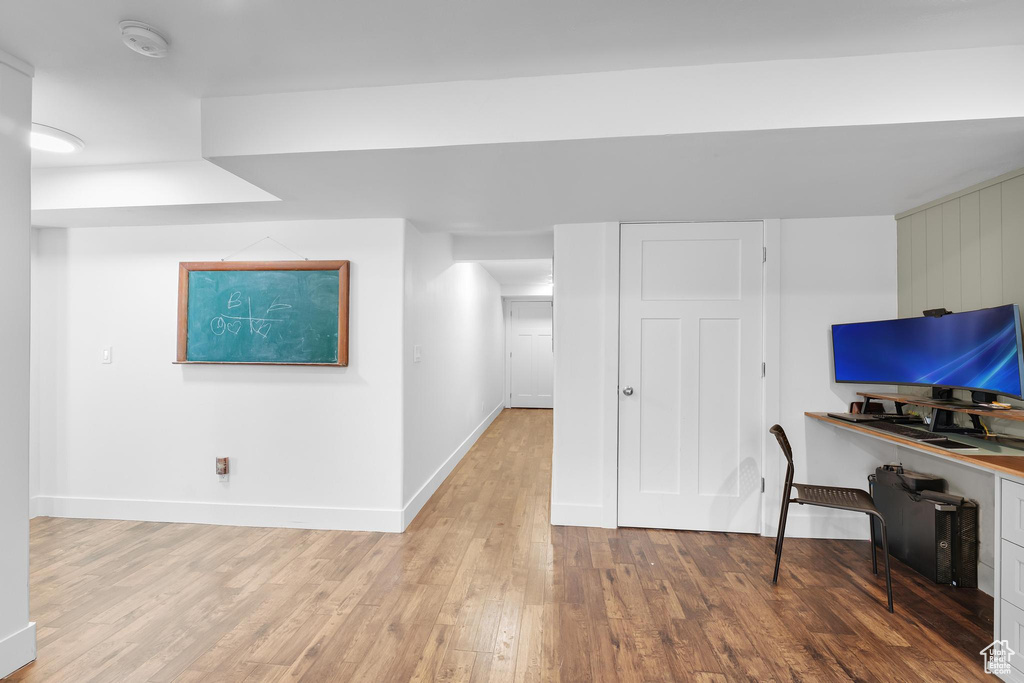 Office area with light wood-style floors and baseboards