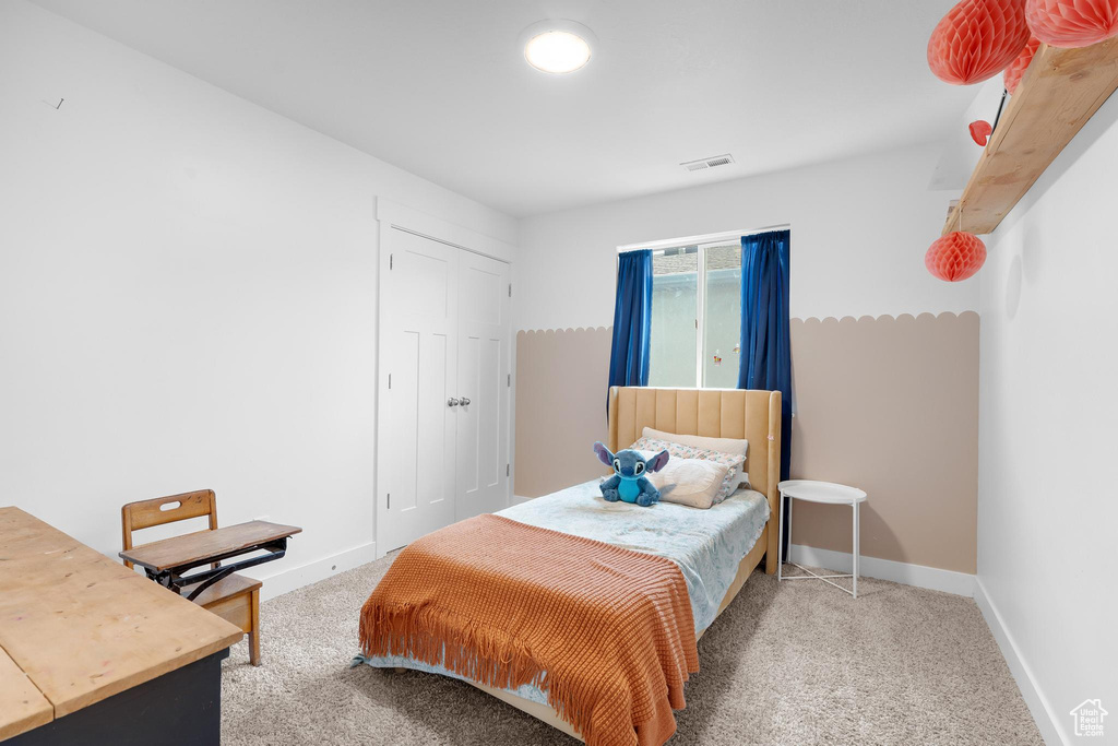 Bedroom with carpet flooring and a closet