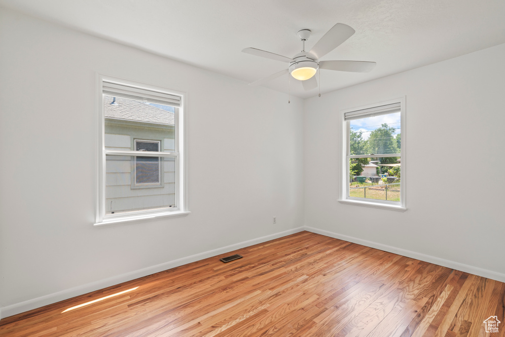 Spare room featuring light wood finished floors and a ceiling fan
