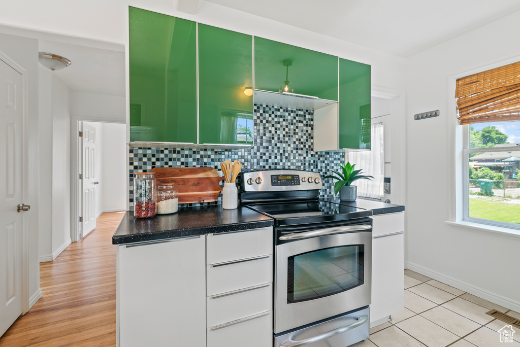 Kitchen featuring stainless steel range with electric cooktop, tasteful backsplash, and plenty of natural light