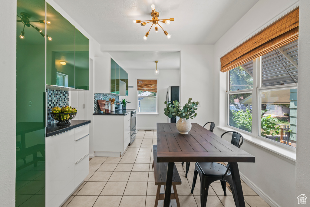 Dining room featuring a chandelier, healthy amount of natural light, and light tile patterned flooring