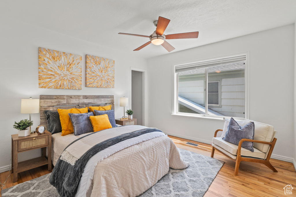 Bedroom with wood finished floors and a ceiling fan