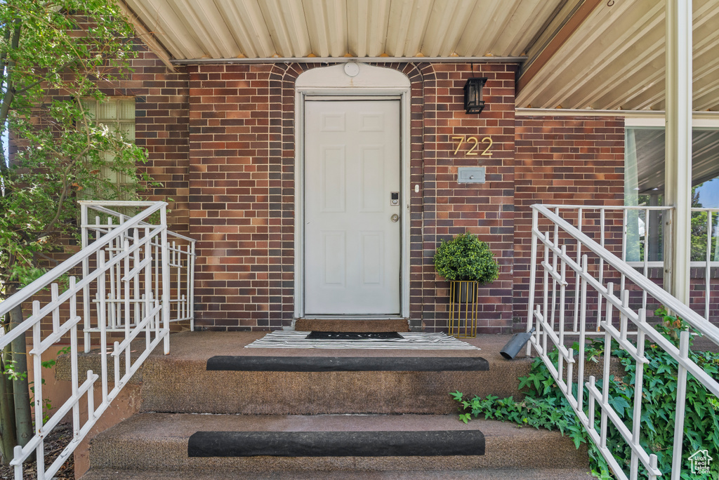 Entrance to property with brick siding