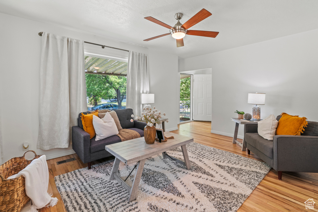 Living room featuring ceiling fan and wood finished floors