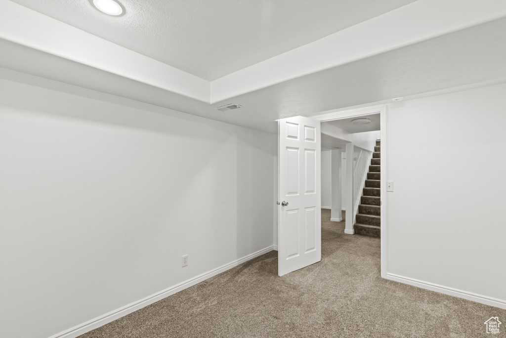 Unfurnished bedroom featuring carpet floors and baseboards