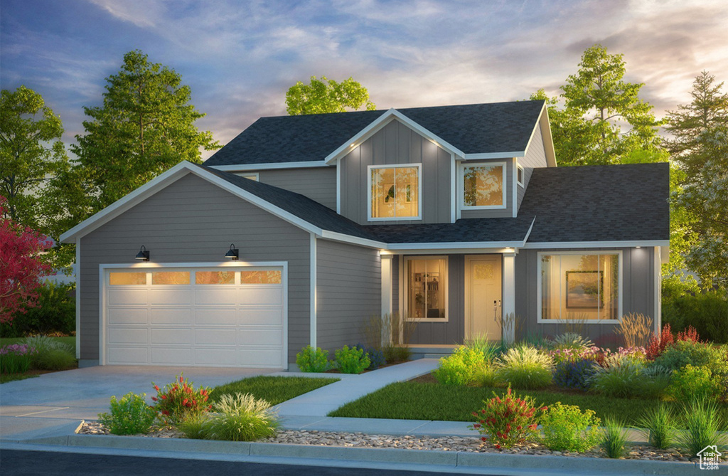 Traditional home featuring driveway, a garage, board and batten siding, and a shingled roof