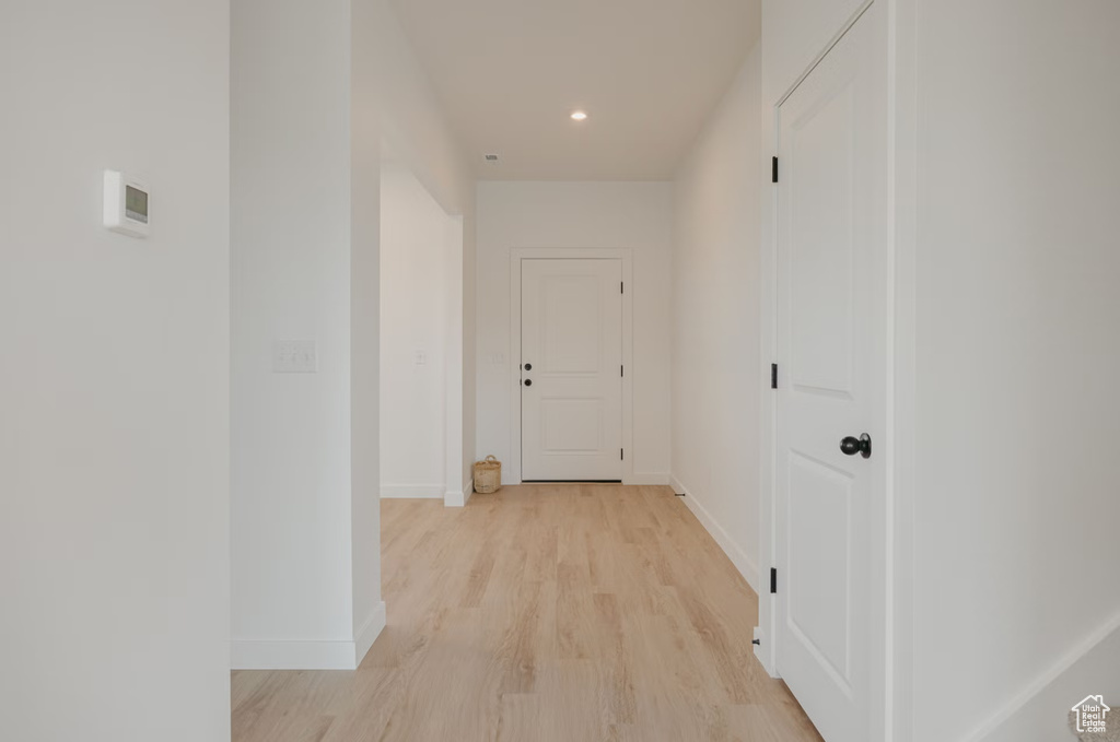 Hall featuring light wood-type flooring and recessed lighting