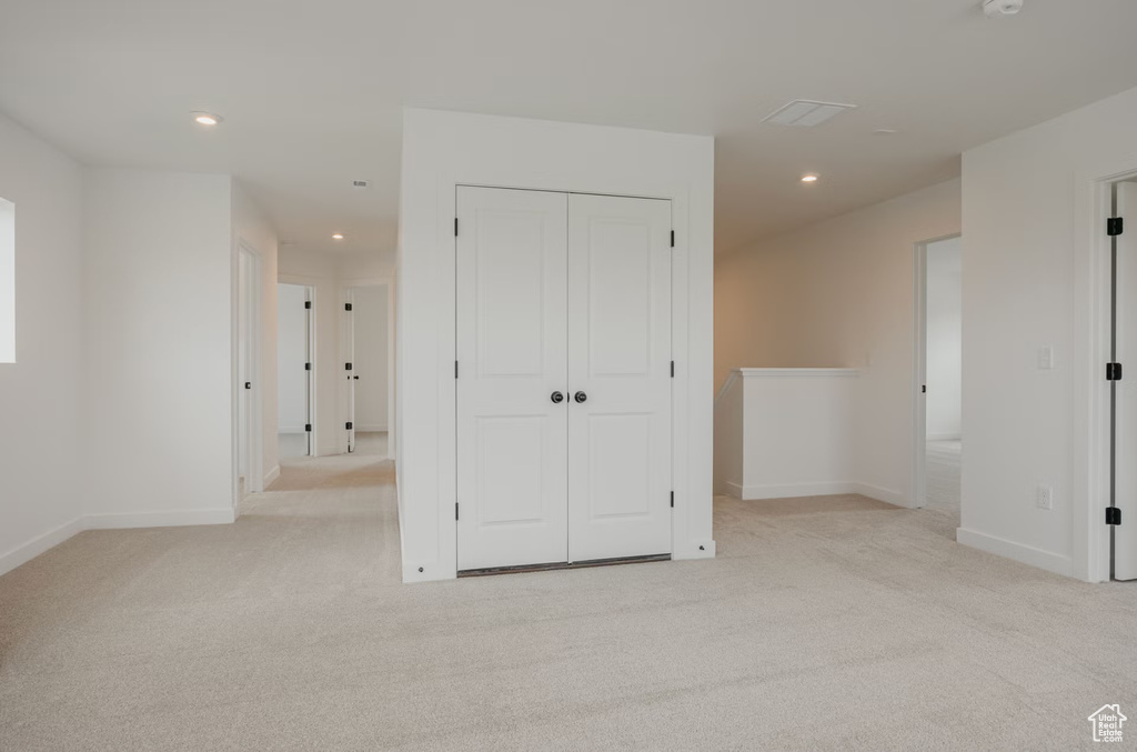 Unfurnished bedroom with carpet floors, recessed lighting, and a closet