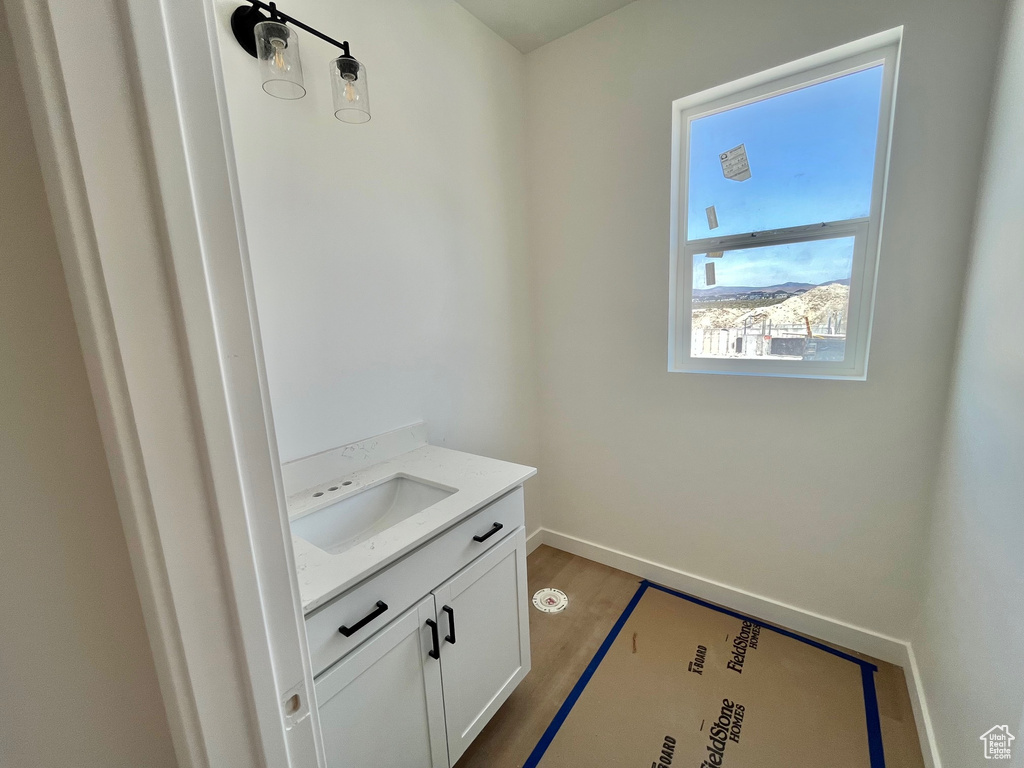 Bathroom featuring vanity and wood finished floors
