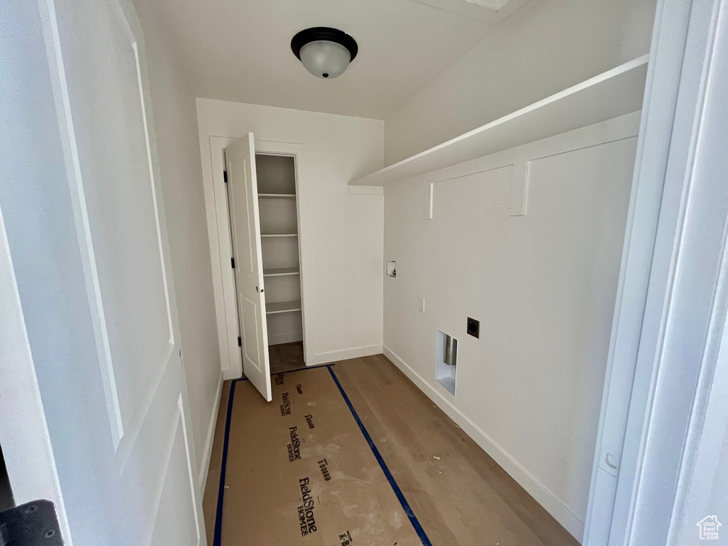 Laundry room with baseboards and electric dryer hookup