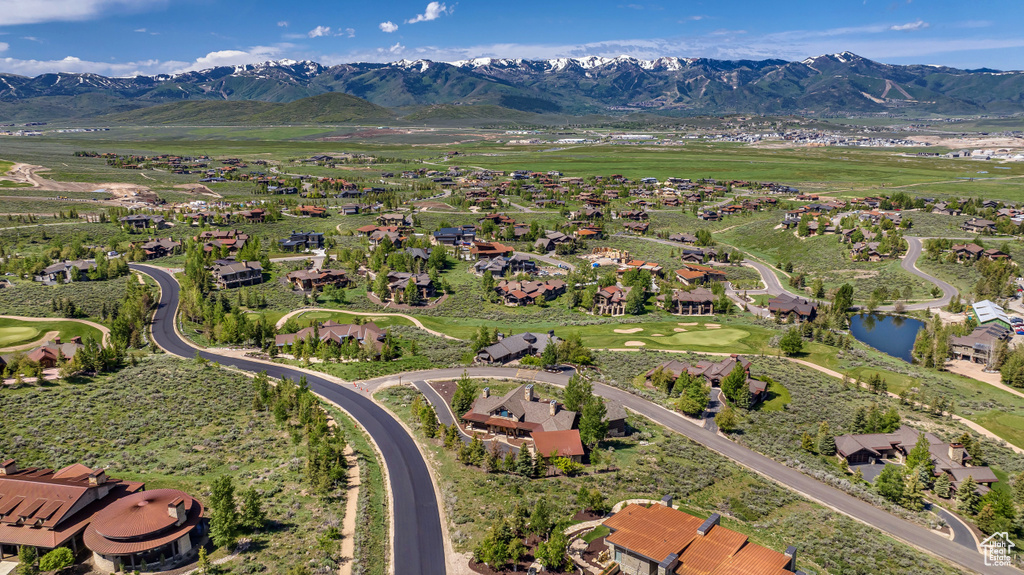 Aerial overview of property's location with nearby suburban area and a water and mountain view