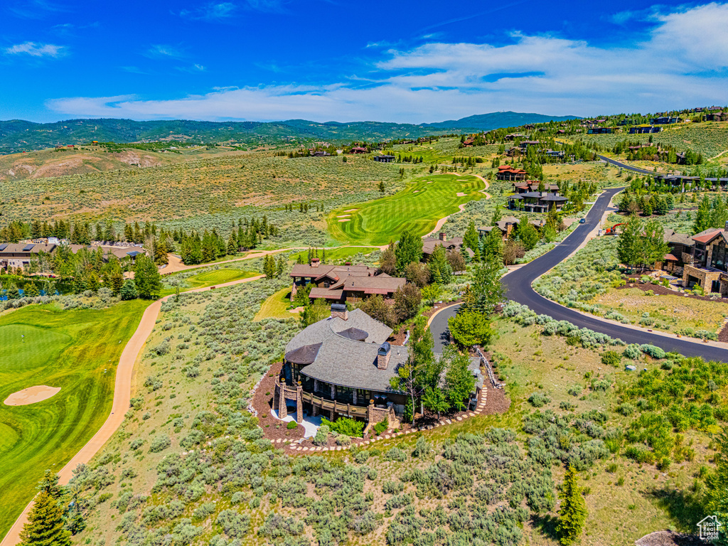 Bird's eye view of a mountainous background and a local golf course