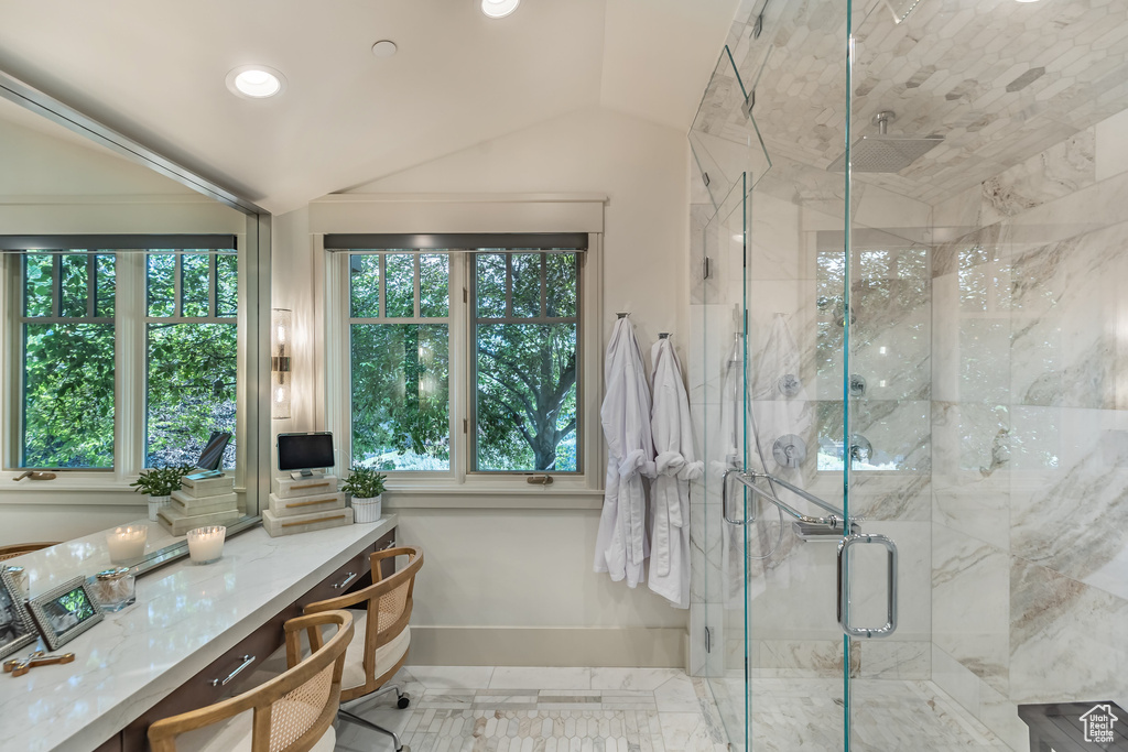 Full bathroom featuring a marble finish shower, lofted ceiling, recessed lighting, and marble finish floors