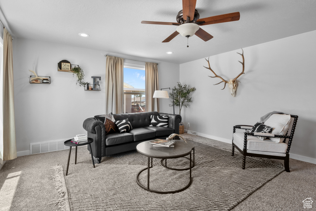 Living room featuring a ceiling fan, carpet flooring, and recessed lighting