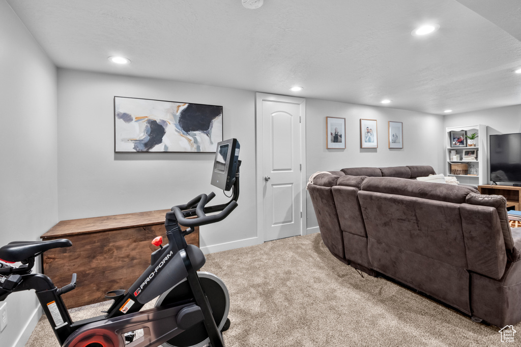 Exercise area with carpet flooring and recessed lighting