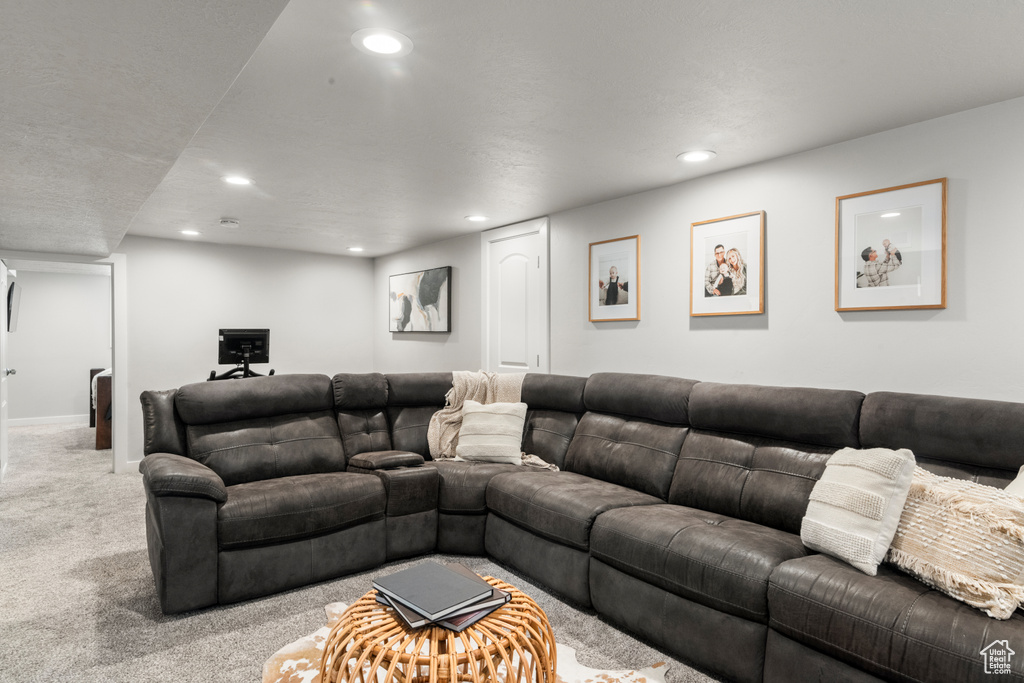Living area with carpet floors and recessed lighting