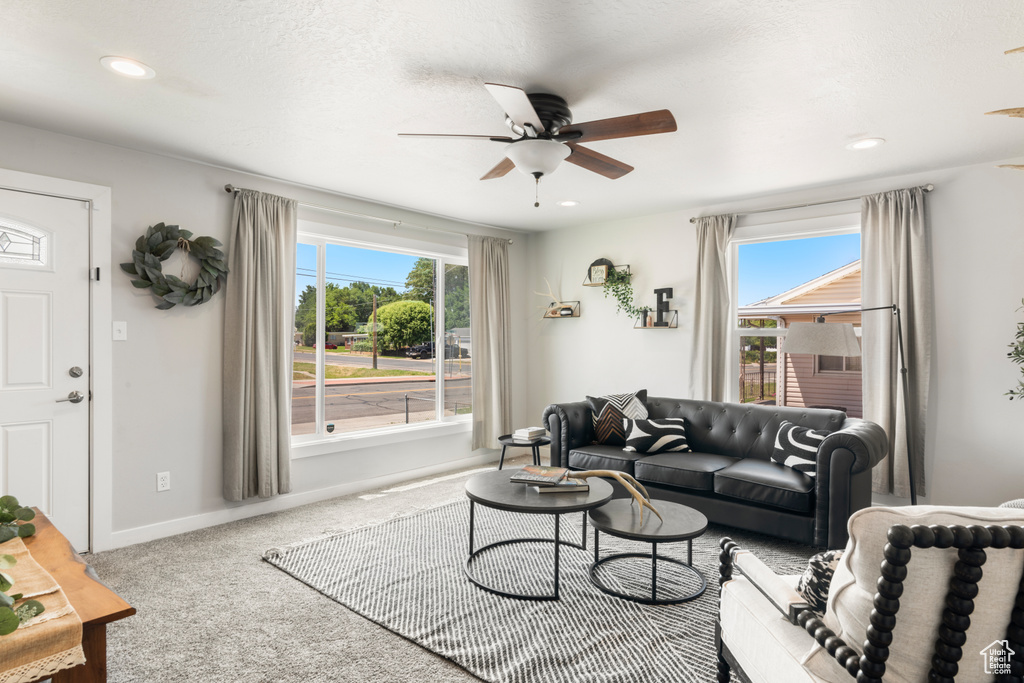 Carpeted living room with ceiling fan, healthy amount of natural light, and recessed lighting
