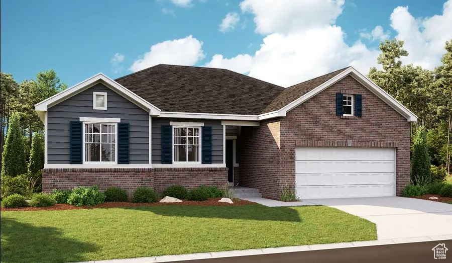 View of front of property with brick siding, concrete driveway, a front yard, and a garage