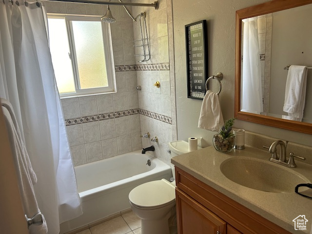 Full bathroom with vanity, shower / tub combo, and tile patterned floors