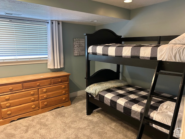 Bedroom featuring light carpet and recessed lighting