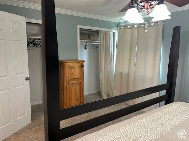 Carpeted bedroom featuring crown molding and ceiling fan