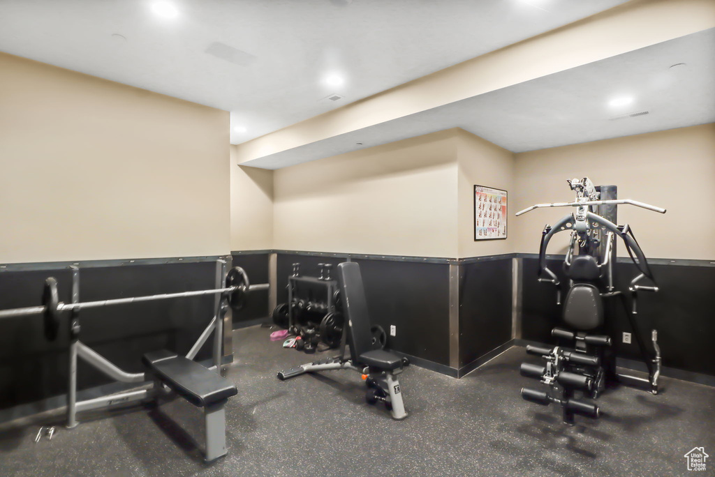 Exercise room featuring a wainscoted wall