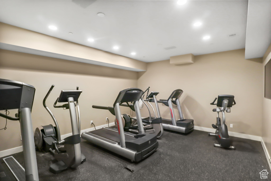 Workout area with baseboards and recessed lighting