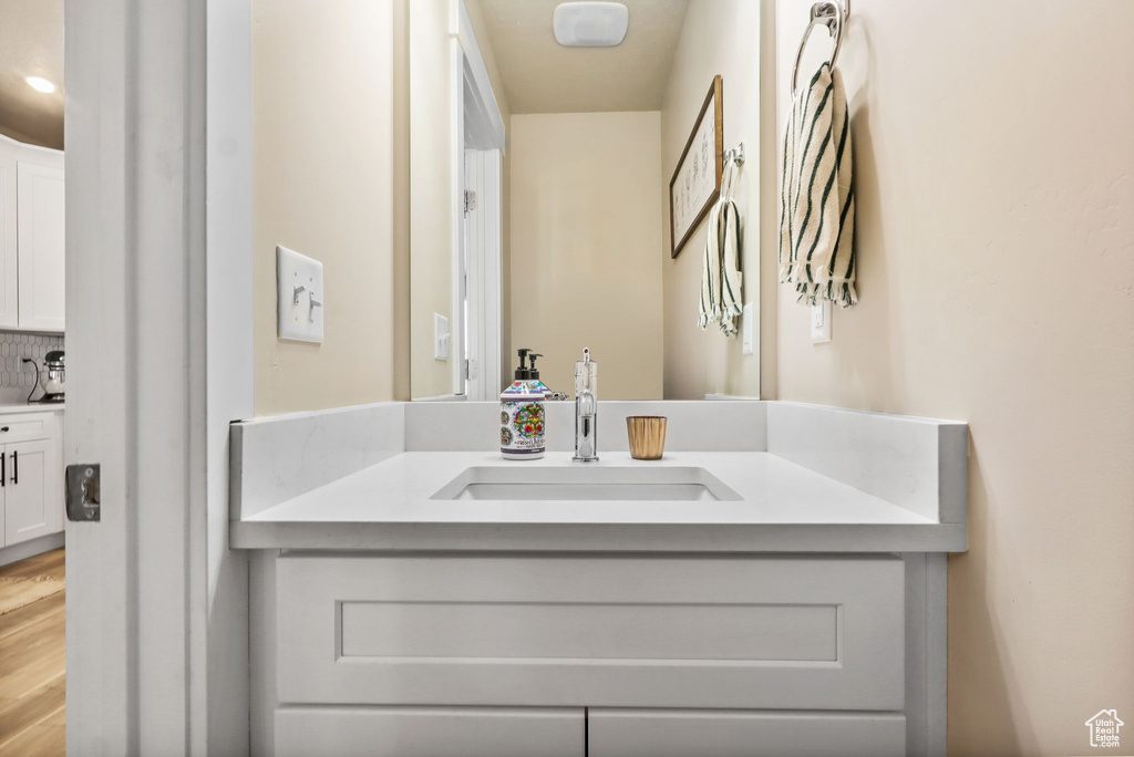 Bathroom featuring vanity and wood finished floors