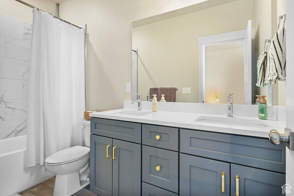 Full bath with double vanity and shower / bath combo
