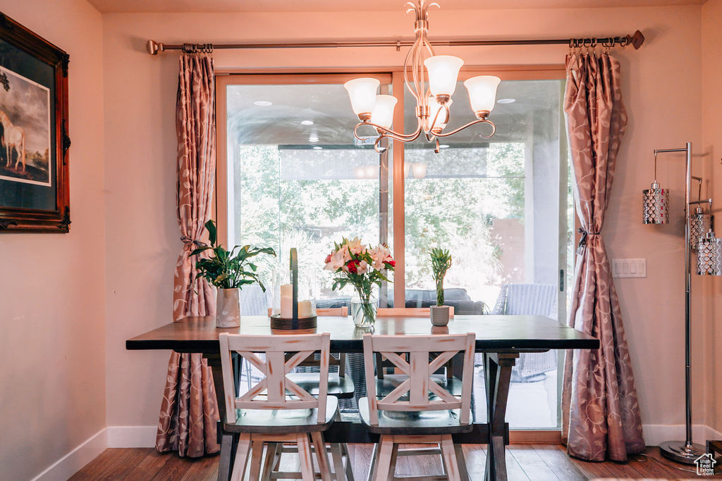 Dining area featuring wood finished floors and a chandelier