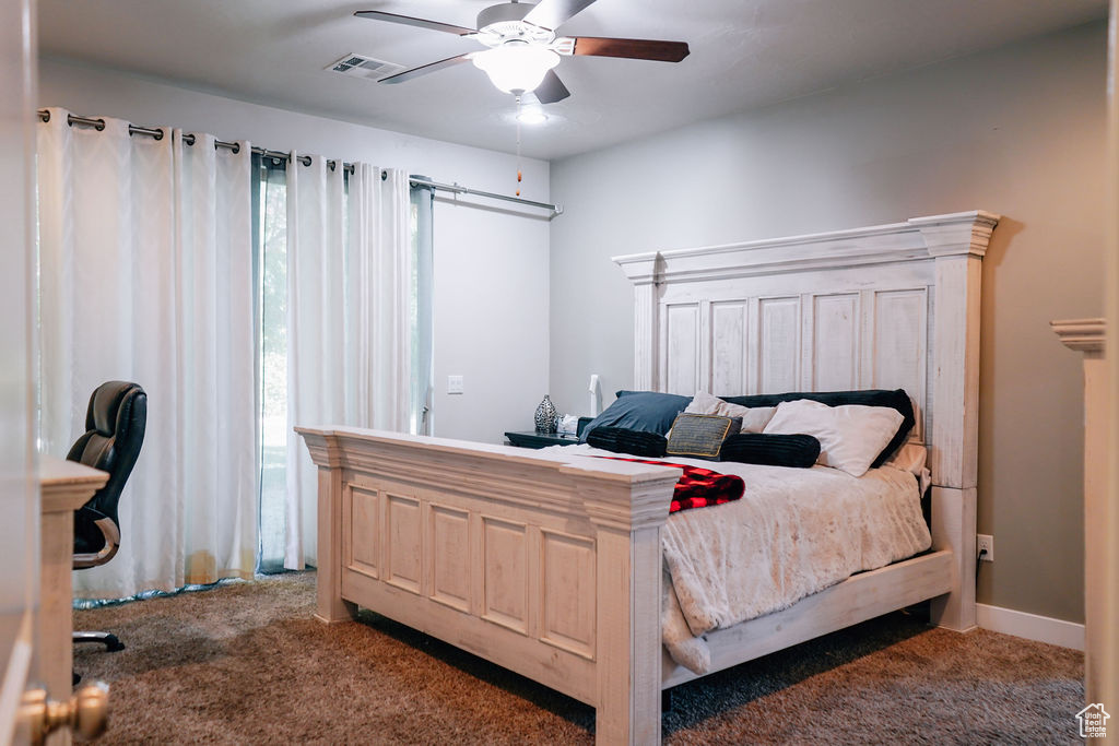 Carpeted bedroom featuring ceiling fan