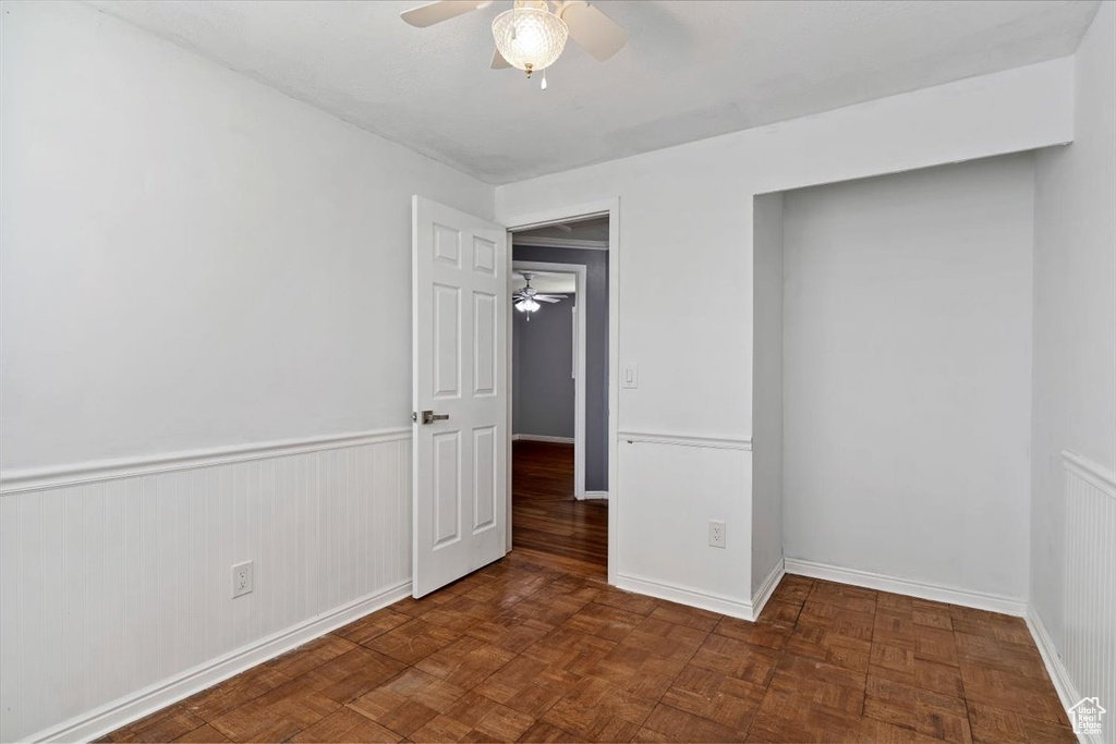 Unfurnished bedroom featuring baseboards and ceiling fan