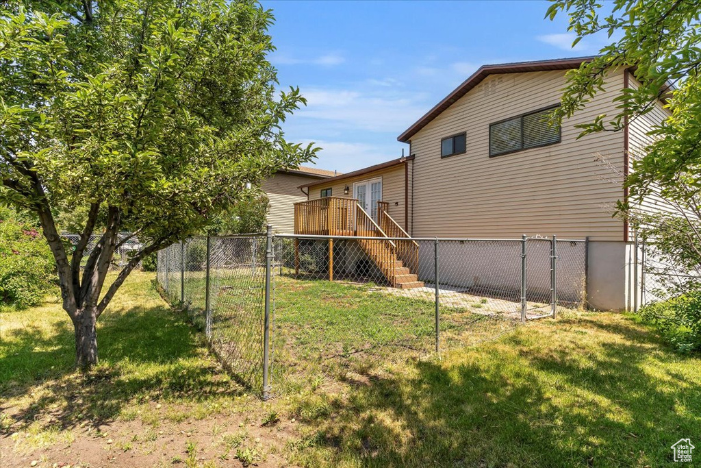 View of yard featuring a deck and stairs