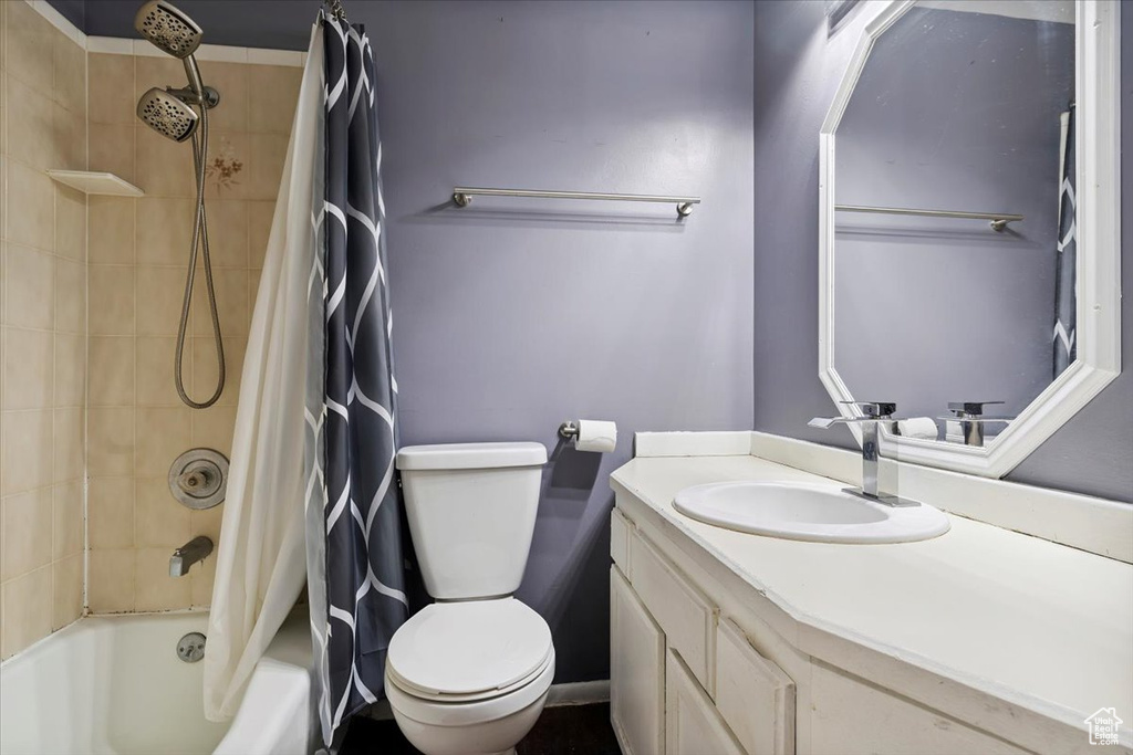 Full bathroom with shower / bathtub combination with curtain and vanity
