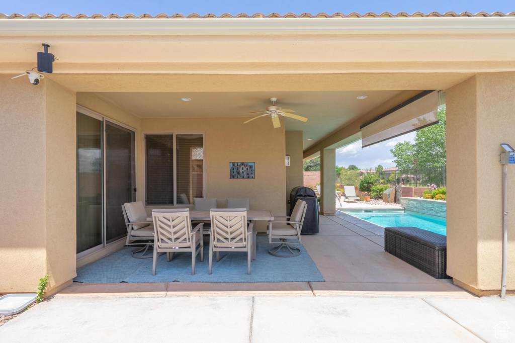 View of patio with ceiling fan and outdoor dining area