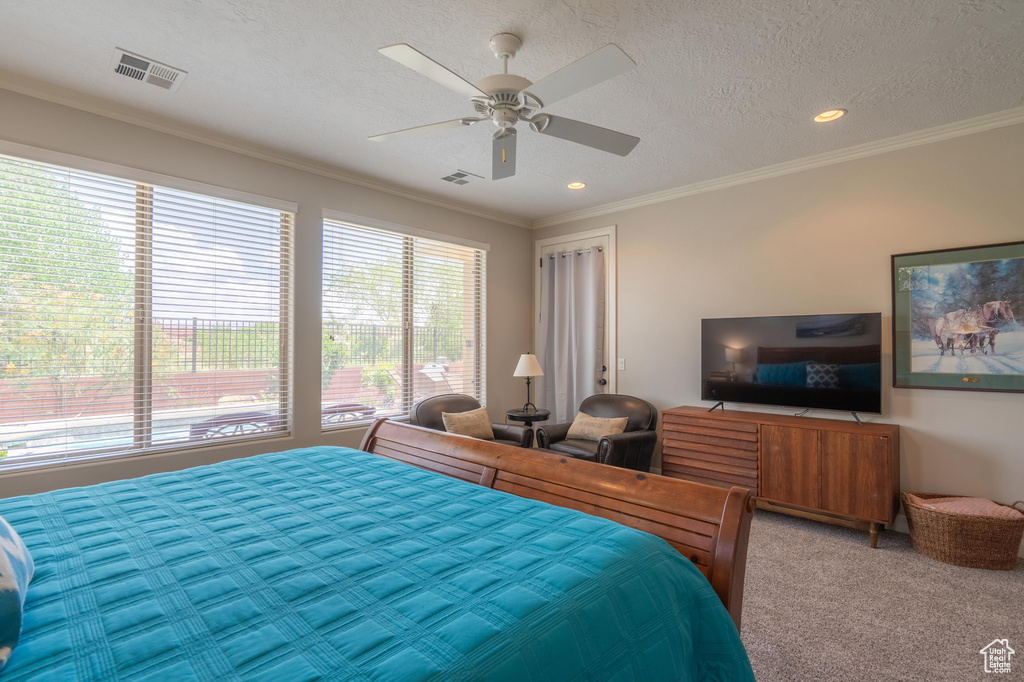 Bedroom with multiple windows, light carpet, ornamental molding, recessed lighting, and a ceiling fan