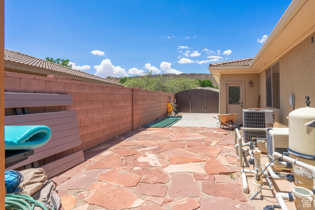 Fenced backyard featuring a patio and a gate