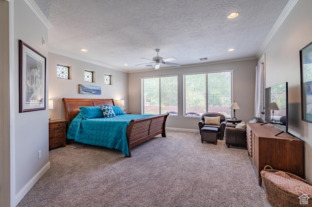 Carpeted bedroom with crown molding, a textured ceiling, recessed lighting, and ceiling fan
