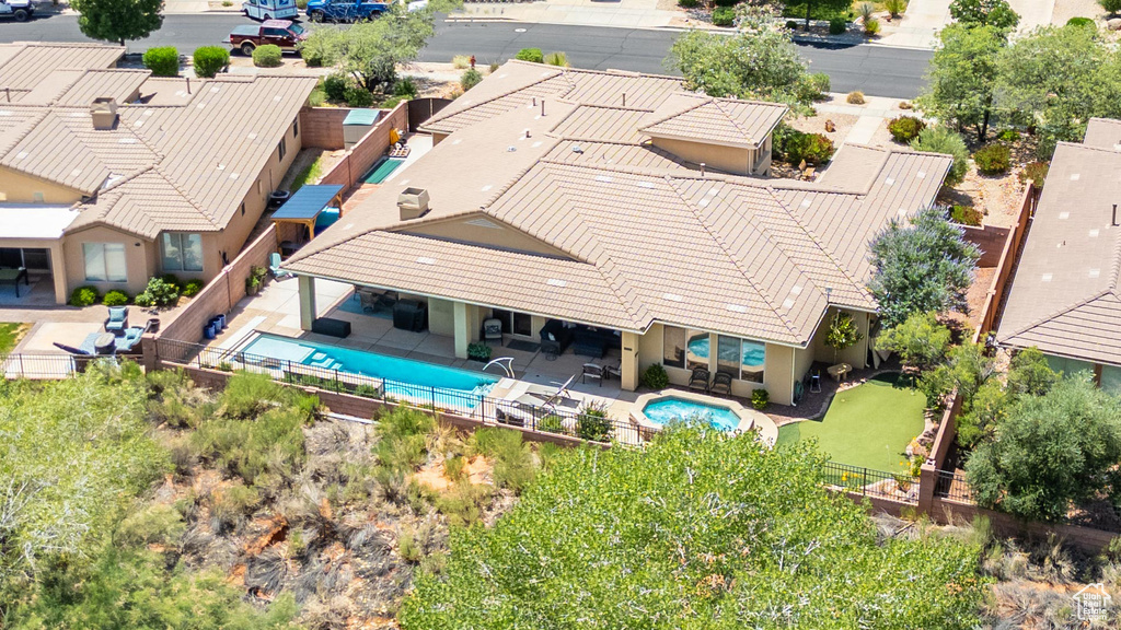 Aerial view of property and surrounding area featuring a pool