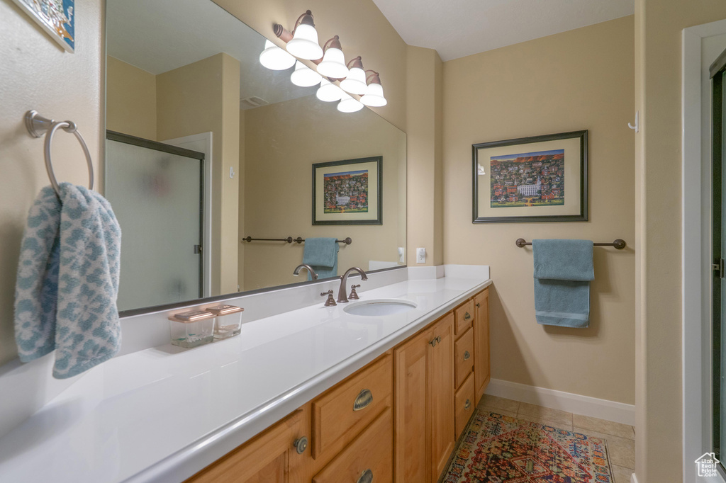Full bath featuring vanity, a shower stall, and tile patterned flooring