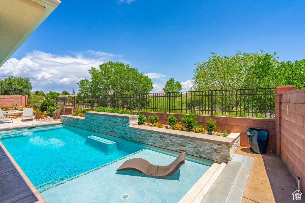 View of swimming pool featuring a patio area and a fenced backyard
